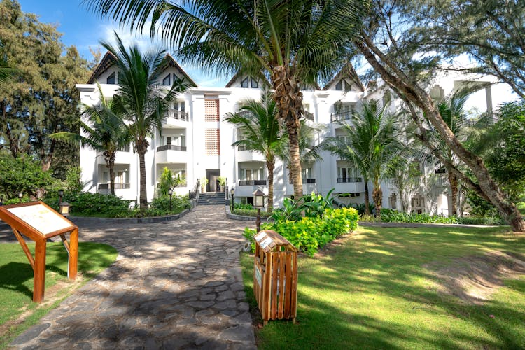 White Residential Building Among Palm Trees