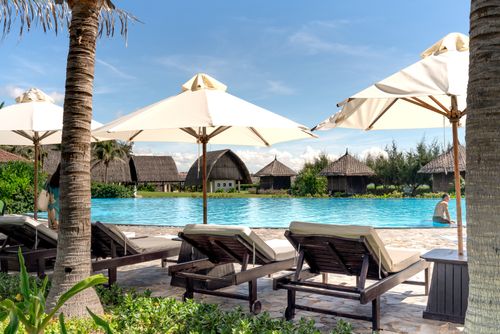 Free Relax by the pool with luxury resort amenities under sunny skies. Stock Photo
