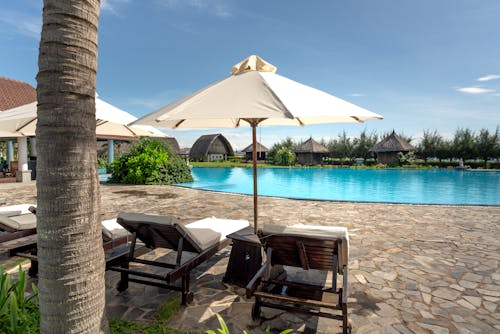 Deck Chairs by a Swimming Pool 