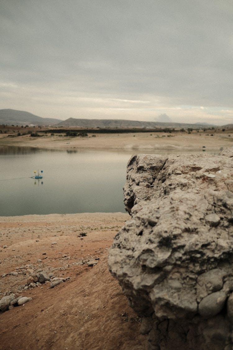 Empty Rocky Shore Under A Cloudy Sky 