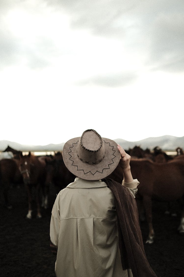 Woman Standing On Riding Horse Arena