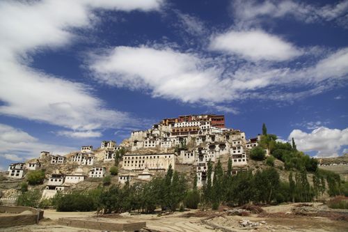 Free Panoramic view of a historic monastery in Ladakh, showcasing ancient architecture against a vibrant sky. Stock Photo