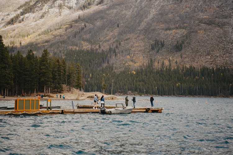 People On A Pier In A Lake In Mountains 