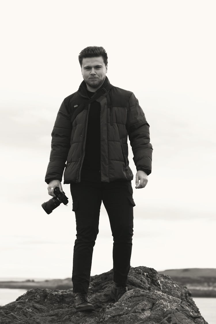 Grayscale Photo Of Man Holding A Camera