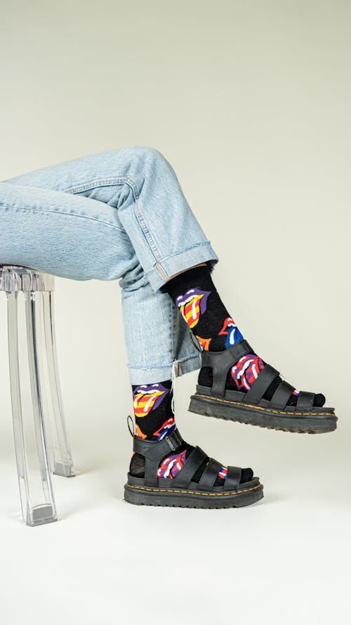 Legs of a Girl Wearing Jeans, Socks and Sandals