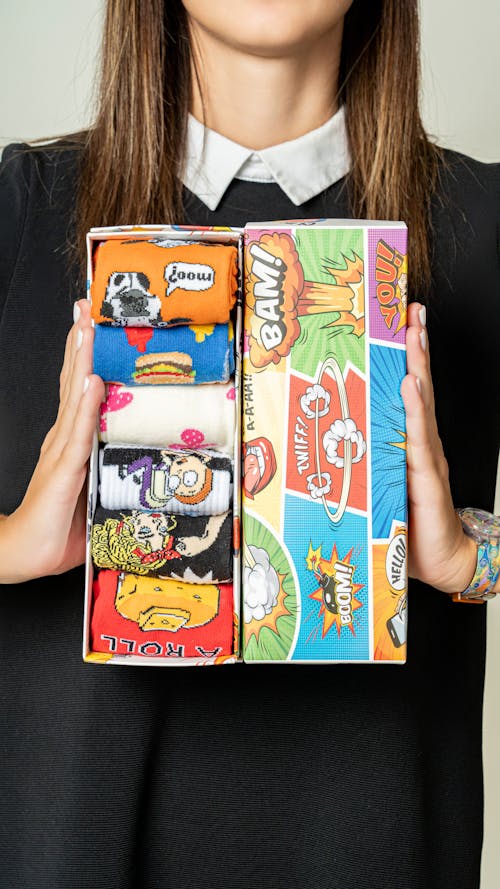 Hands Holding Box of Comic Style Socks