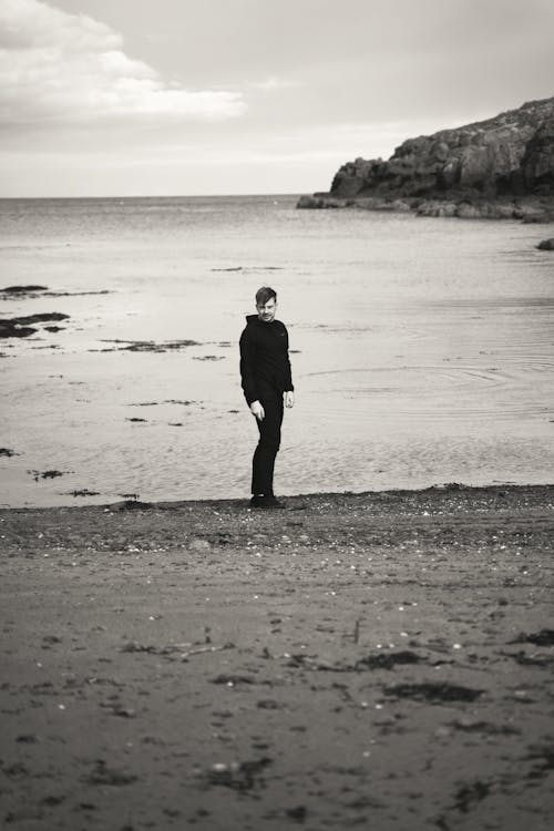 Grayscale Photo of a Man in the Beach