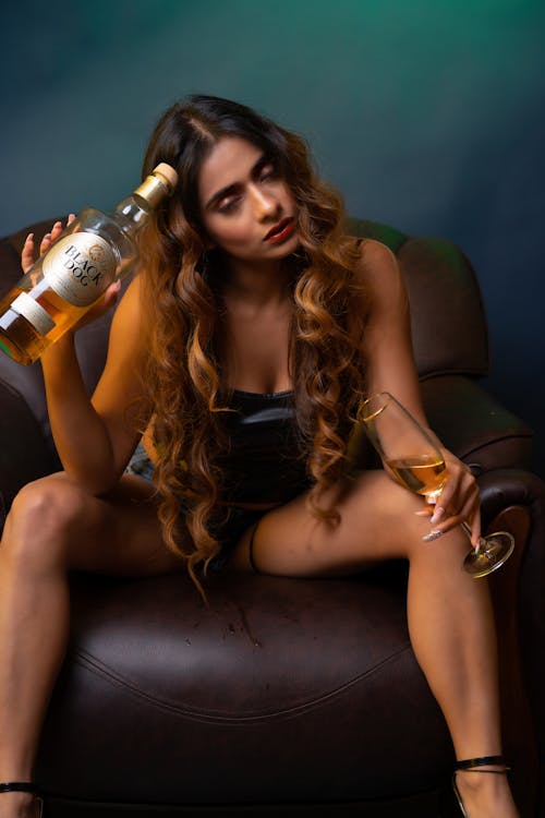 Photo of Woman sitting on Brown Arm Chair