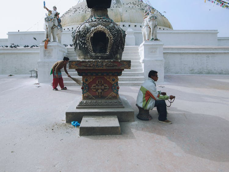 Woman Cleaning Buddhist Temple 