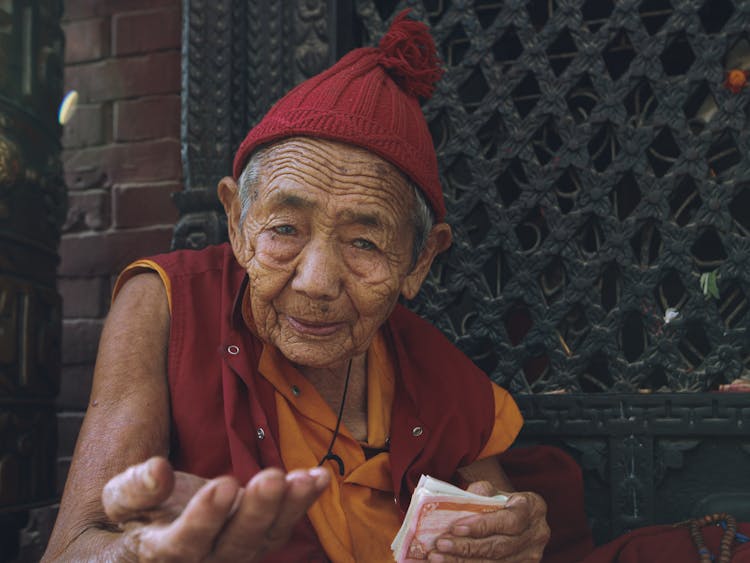 An Elderly Man Begging For Money