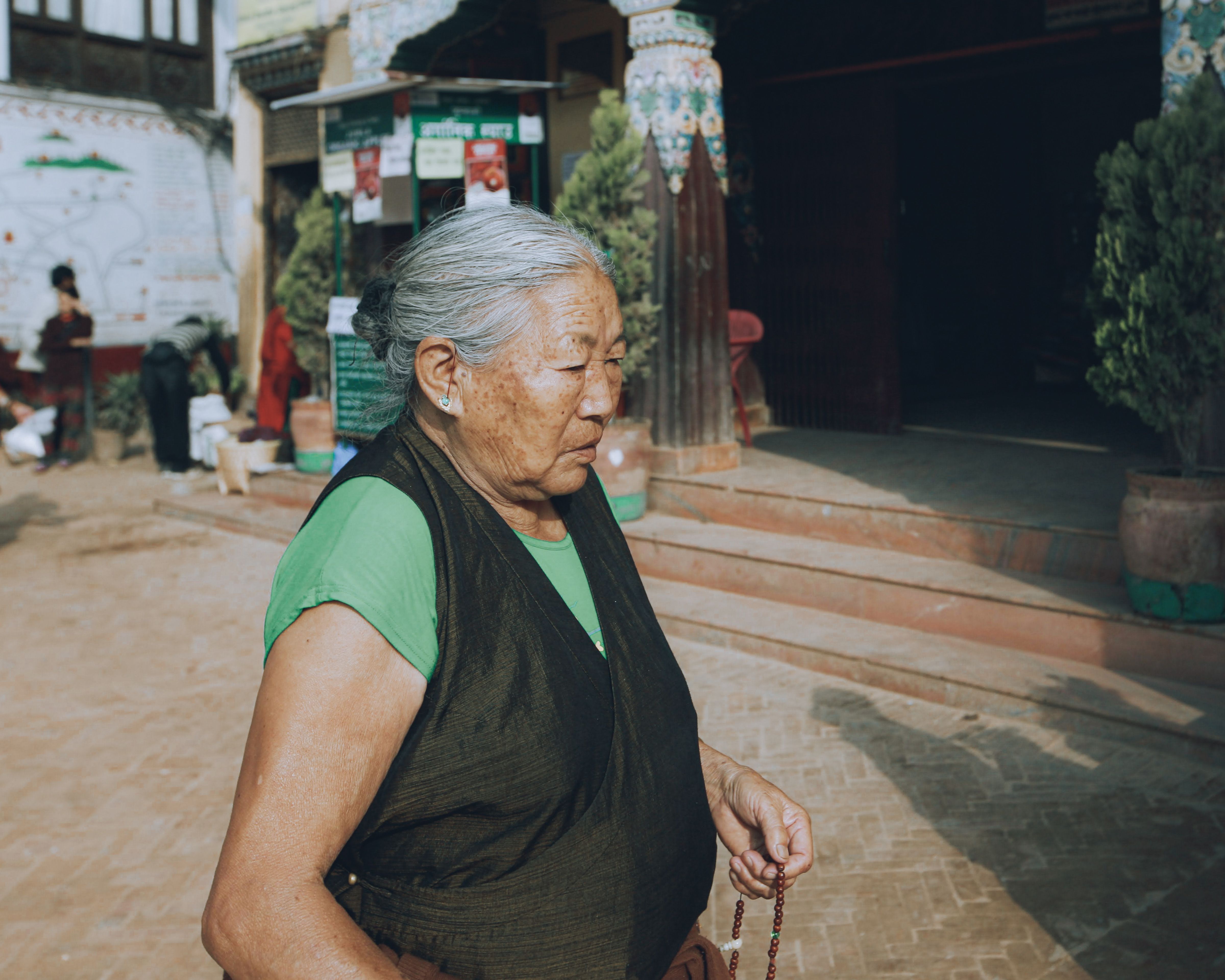 Eldery Woman with Prayer Beads in her Hand · Free Stock Photo