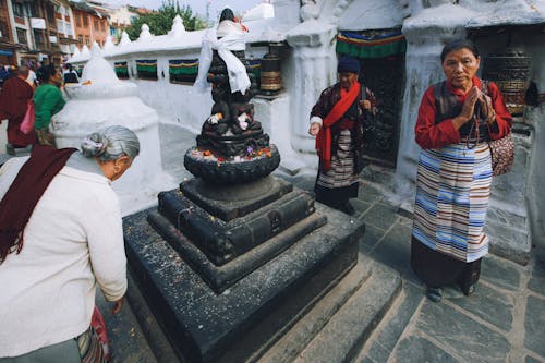 Women Praying in front of a Statue in Kathmandu, Nepal 