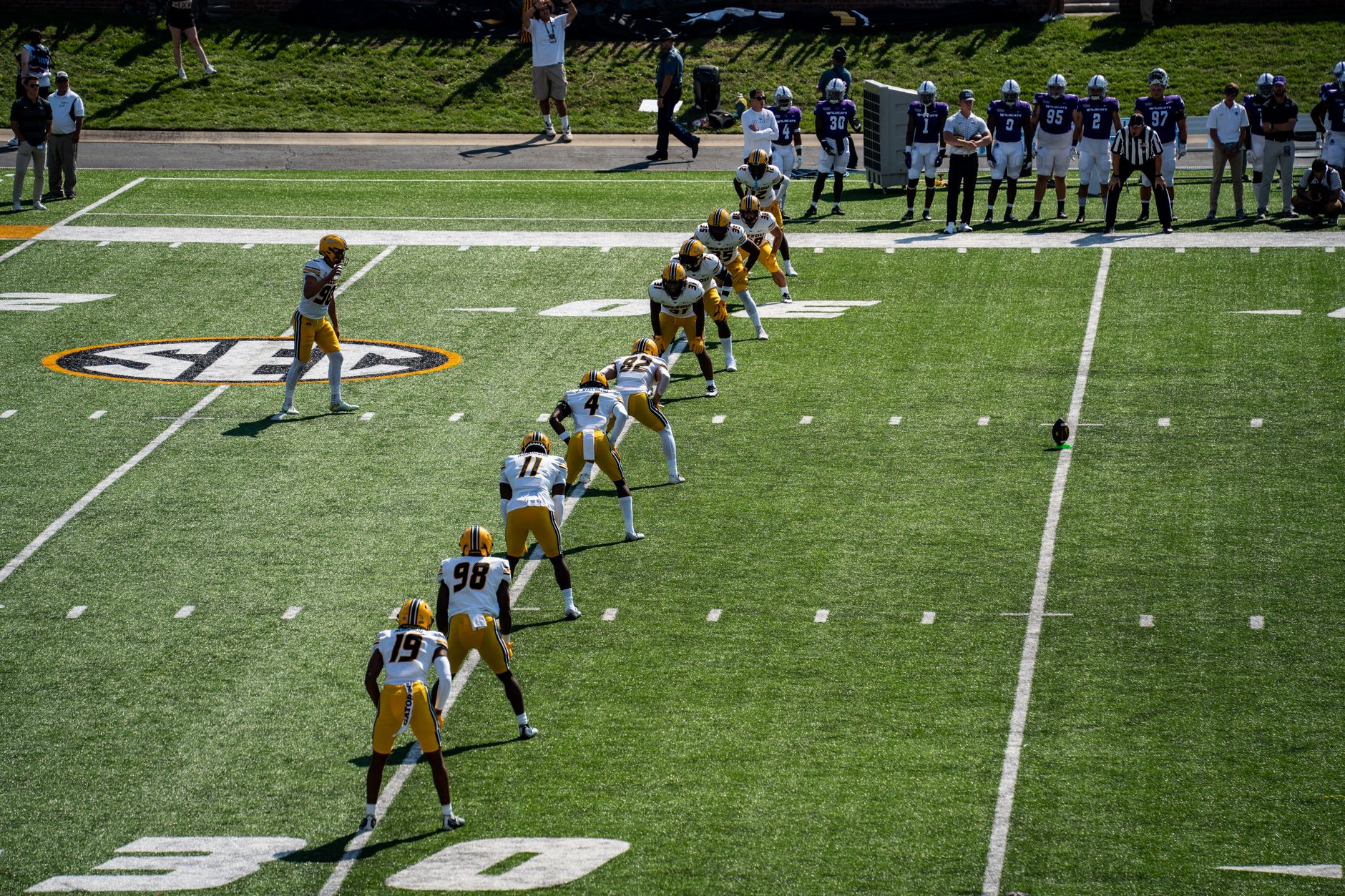 Aerial shot of an American football game kickoff with players in action.