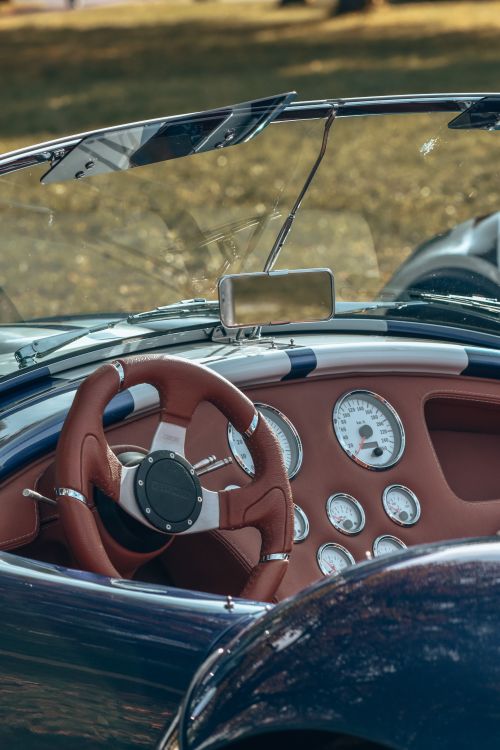 Free Interior of a vintage convertible car featuring a brown leather steering wheel and classic dashboard. Stock Photo