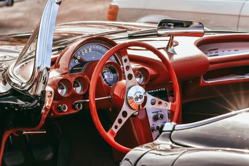 Free Interior view of a vintage Corvette convertible with red leather and classic dashboard. Stock Photo
