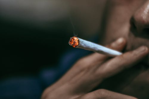 Close Up Photo of Person Smoking