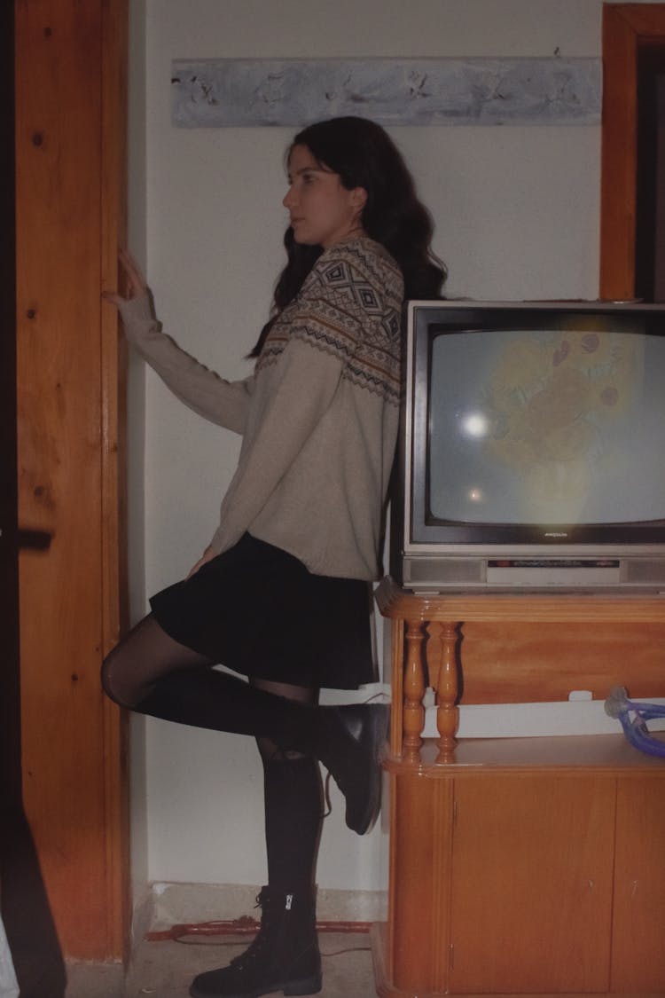 Woman Leaning On A Television