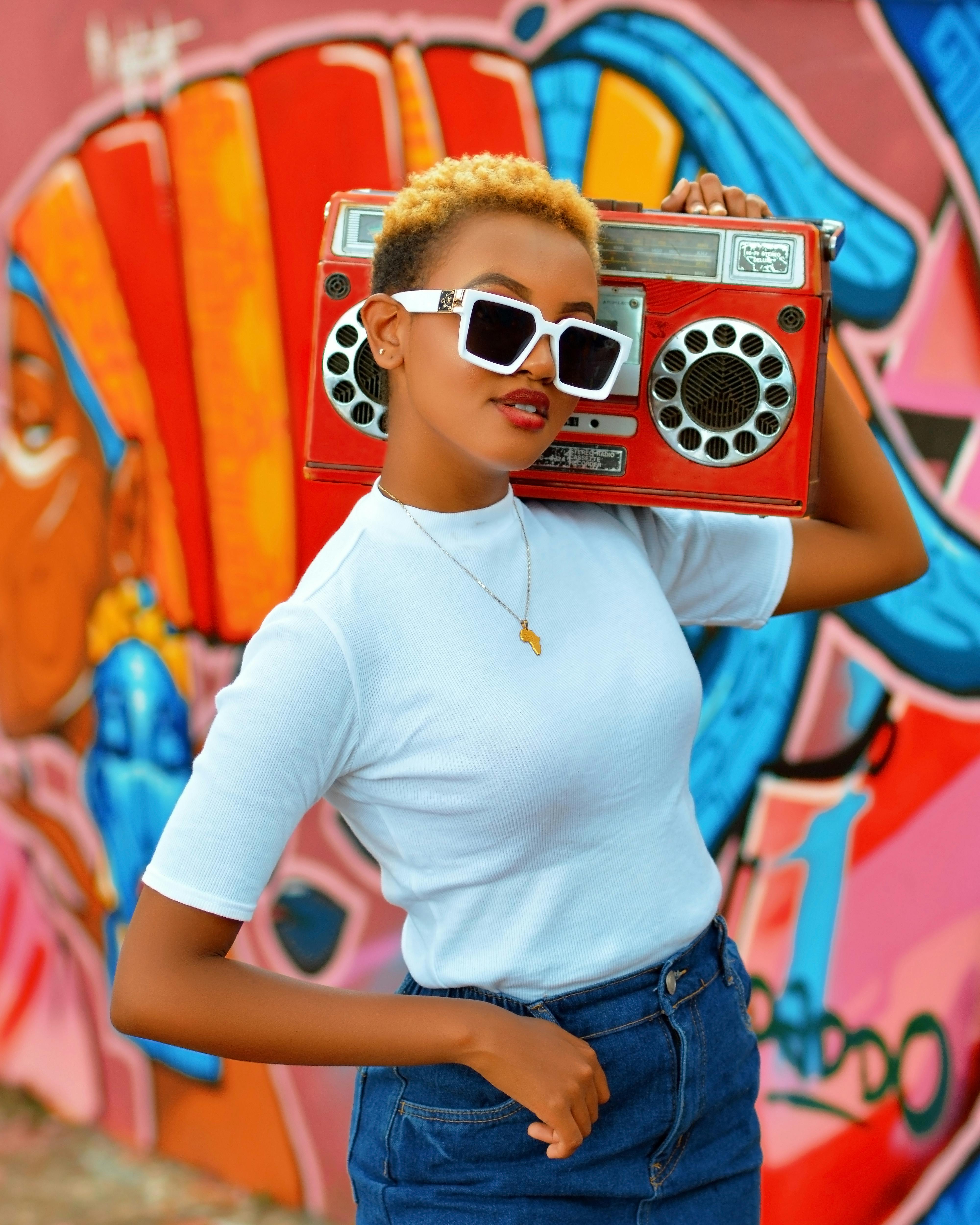 woman holding a boombox on her shoulder