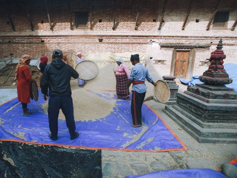 People Filtering Cereal in Temple