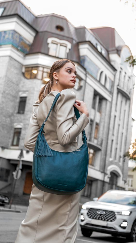 Woman with a leather tote over monochrome basics