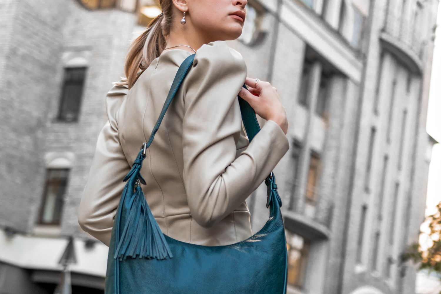 Woman with a leather tote over monochrome basics
