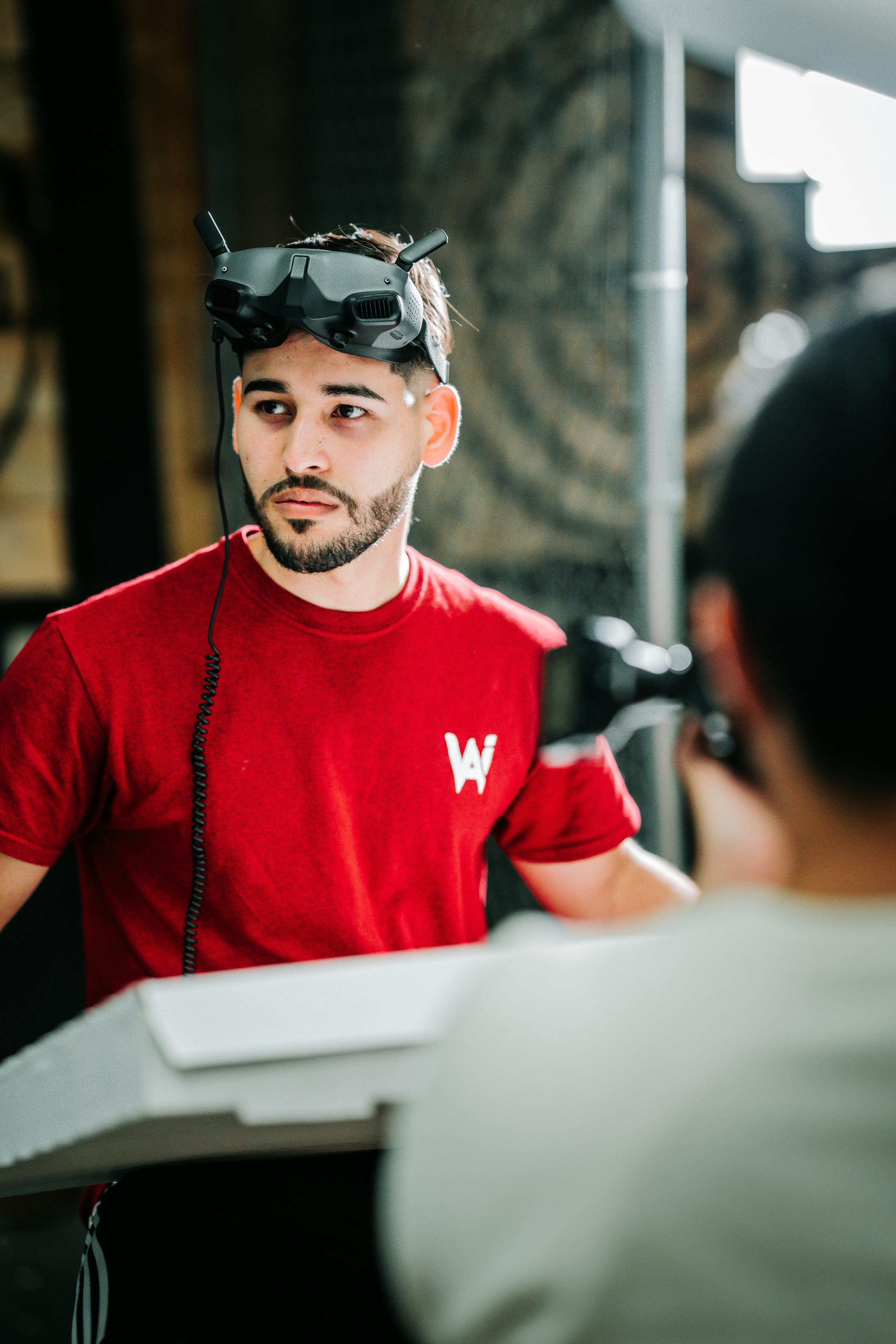 a photographer taking photo of a male model wearing a vr goggles