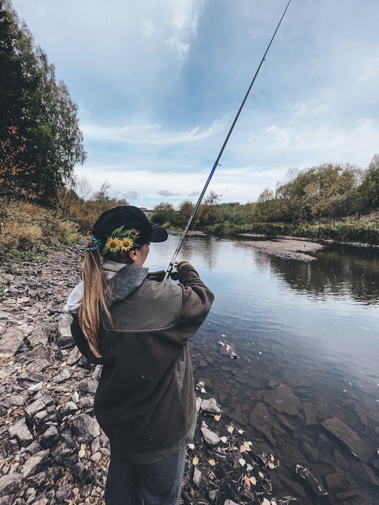 A Woman Fishing On The Lake