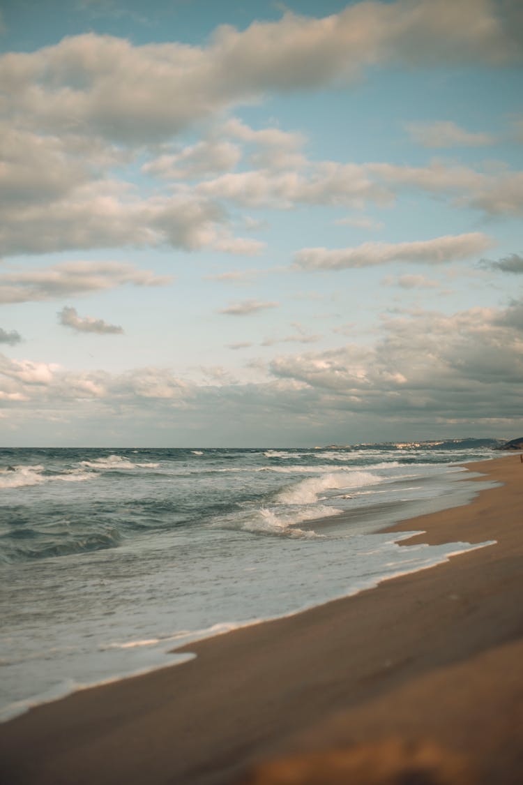 Clouds Over A Sandy Beach