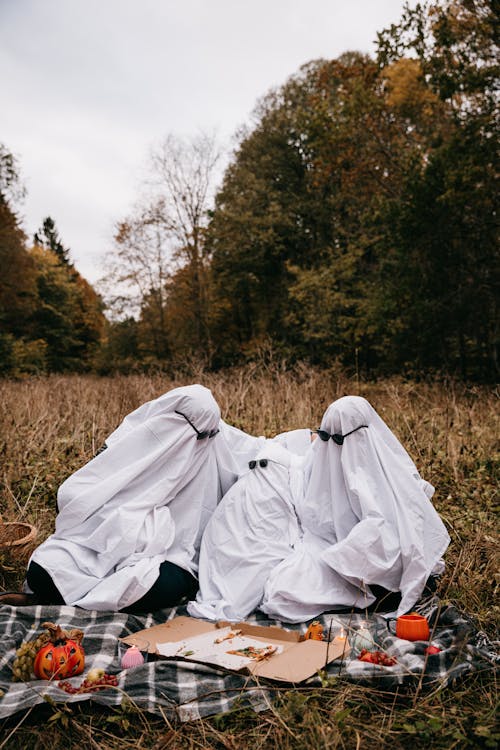 People in Ghost Costumes Having Picnic in Park