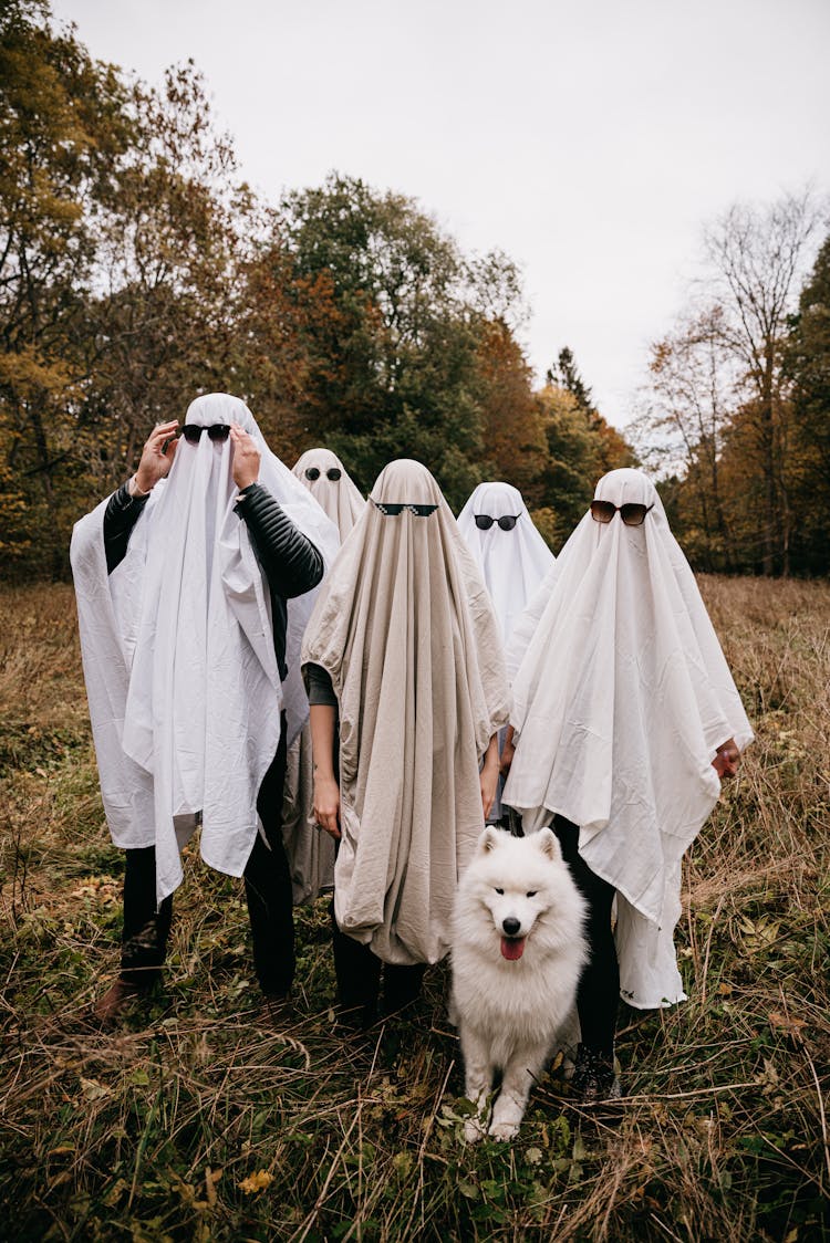 Group Of People In Ghost Costumes Standing In Field