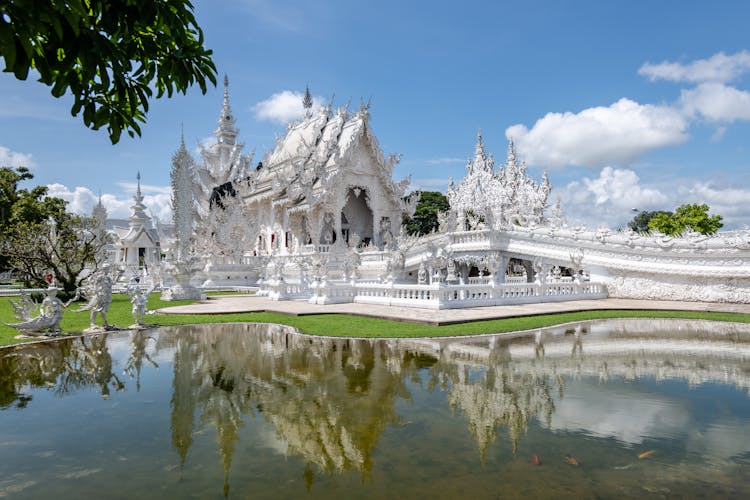 White Temple Near Lake Under Blue Sky