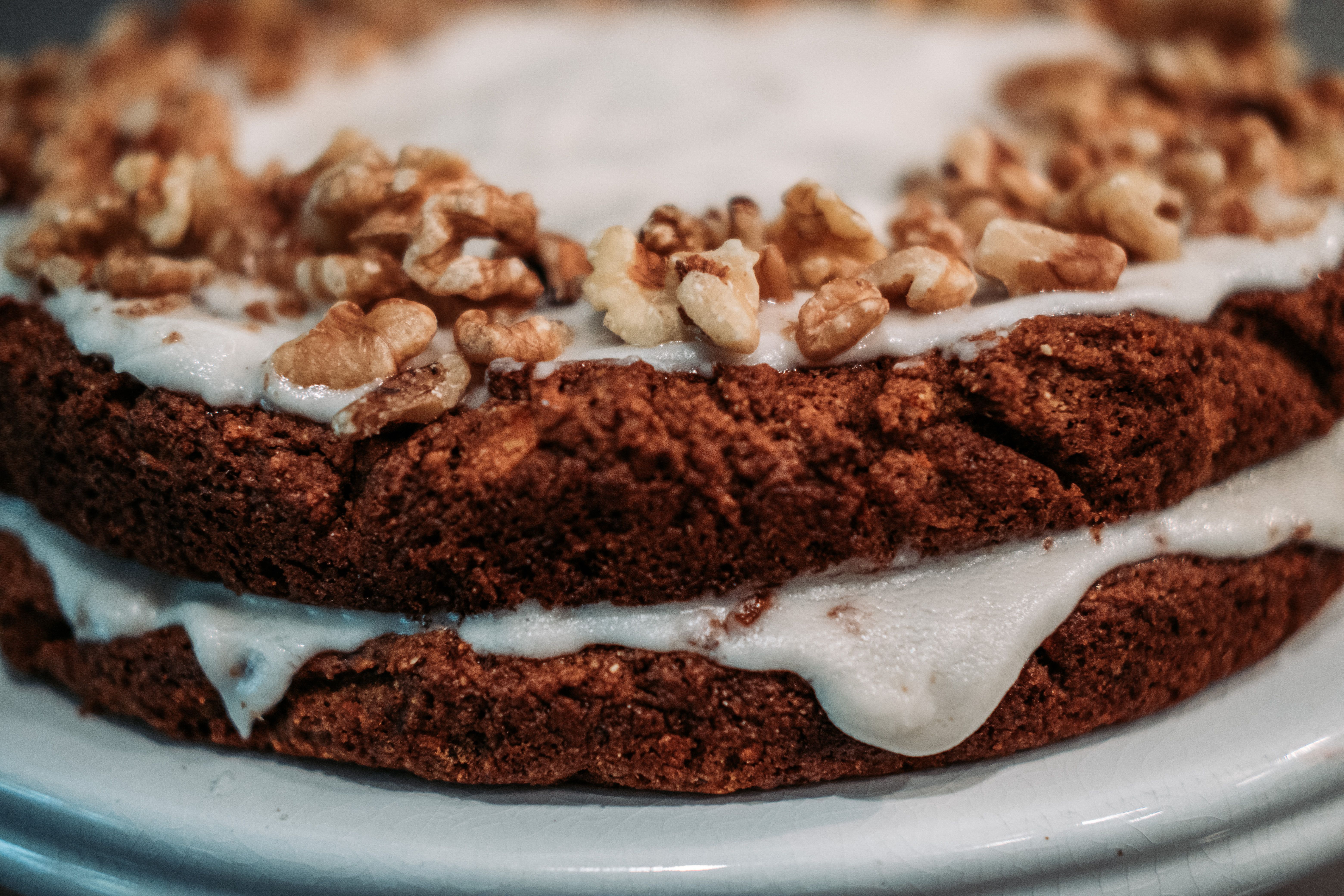 Close-up of frosted banana cupcakes with chopped macadamia nuts