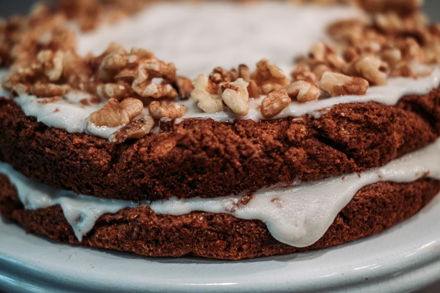 Layered chocolate cake topped with walnuts