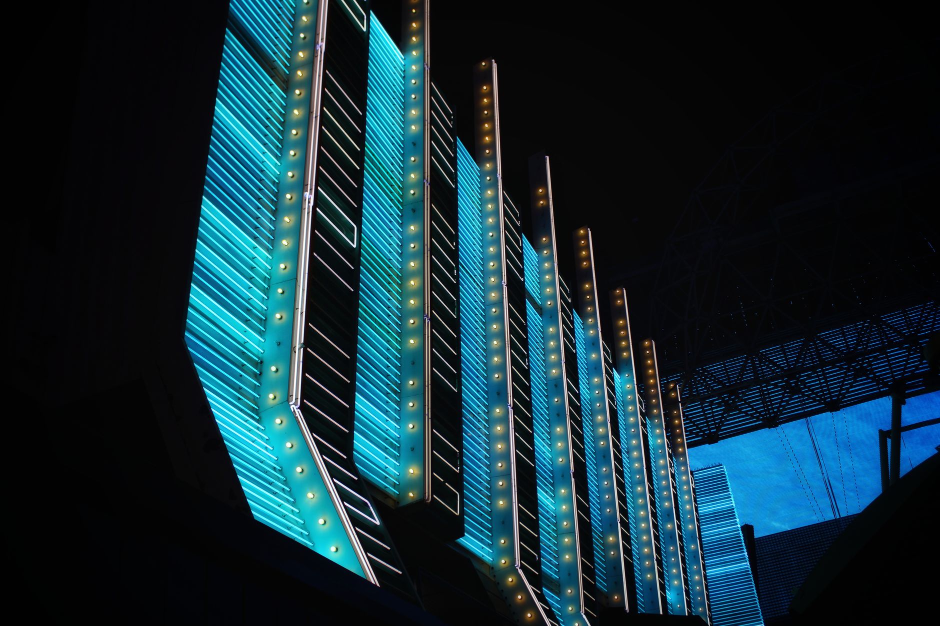 Vibrant neon lights illuminate modern architecture in the heart of Las Vegas at night. Vibrant neon lights illuminate modern architecture in the heart of Las Vegas at night.