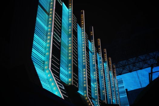 Vibrant neon lights illuminate modern architecture in the heart of Las Vegas at night.