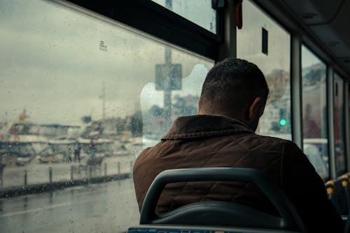 Back View of a Man Sitting on the Train