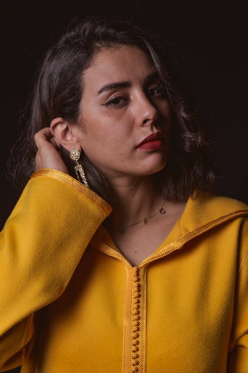 Woman in Yellow Jacket Holding Her Hair