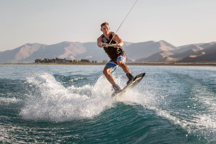 Strong Man Surfing On Sea 