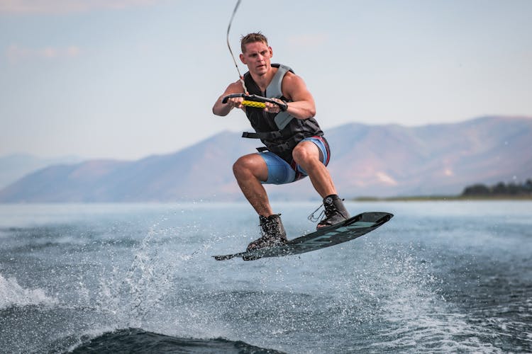 Strong Man Surfing On Sea 