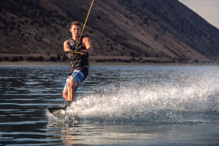 Strong Man Surfing On Sea 