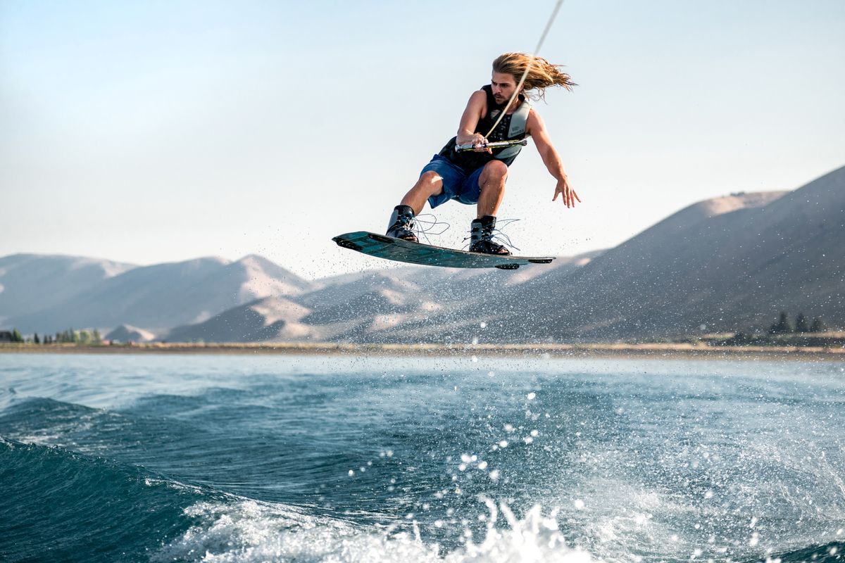 Rider gliding across a sunny lake