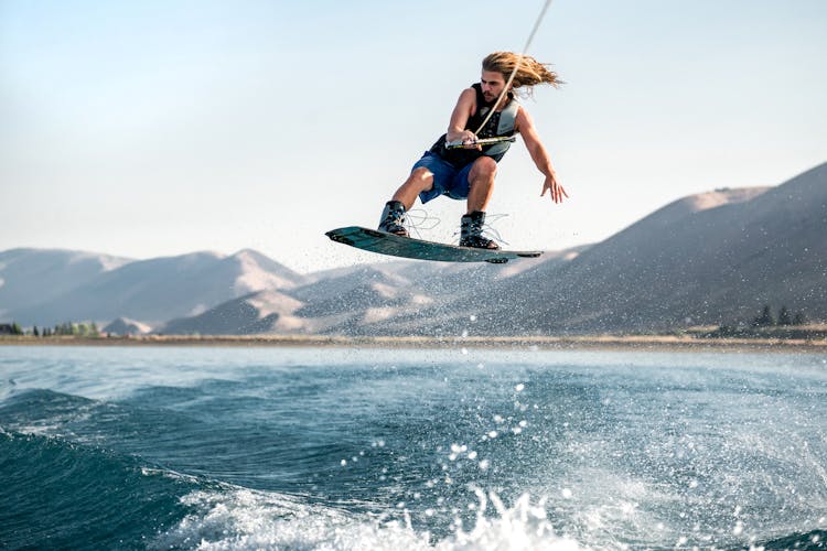 Strong Man Surfing On Sea 