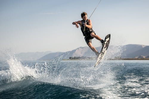 Strong Man Surfing on Sea 