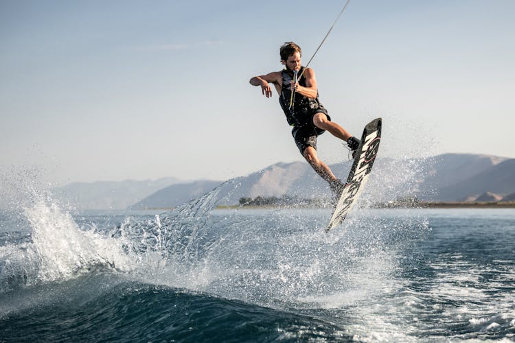 Strong Man Surfing On Sea 