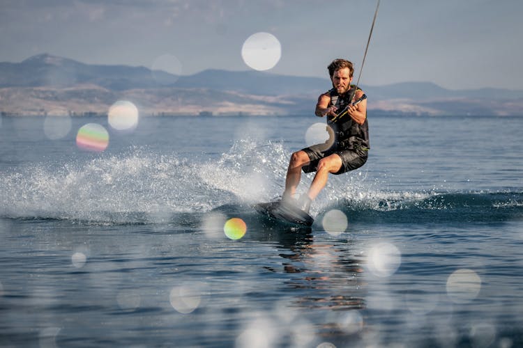 Strong Man Surfing On Sea 