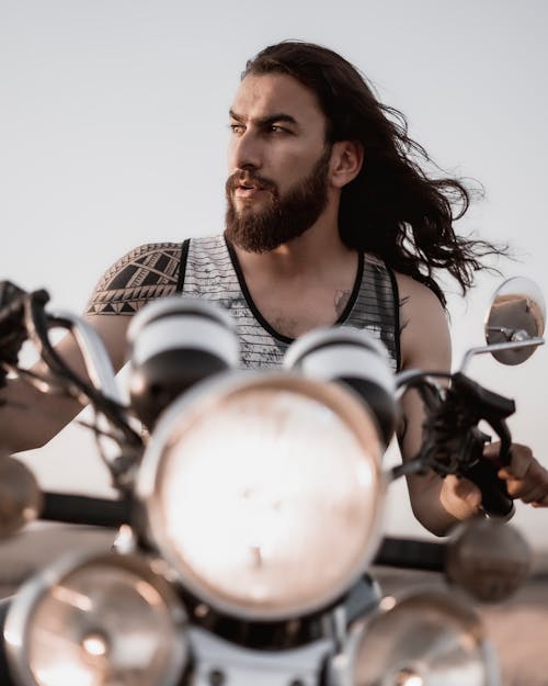 Man with Long Hair Riding a Motorcycle