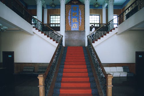 Red Carpeted Staircase Inside a Building