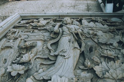 Free A detailed stone carving depicting religious and cultural motifs on a historical wall. Stock Photo