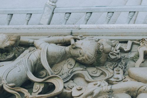 Free Intricate stone carving of a cultural sculpture with elaborate details and ornamental design. Stock Photo