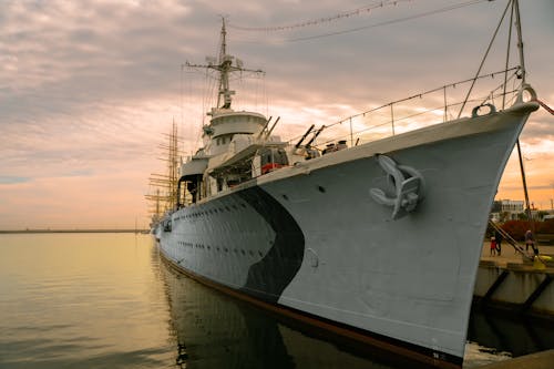 A Battleship Docked on a Pier